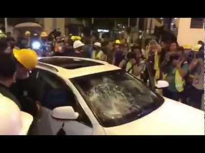 A clueless driver ran into Protesters blockade was attacked by protesters and car vandalized