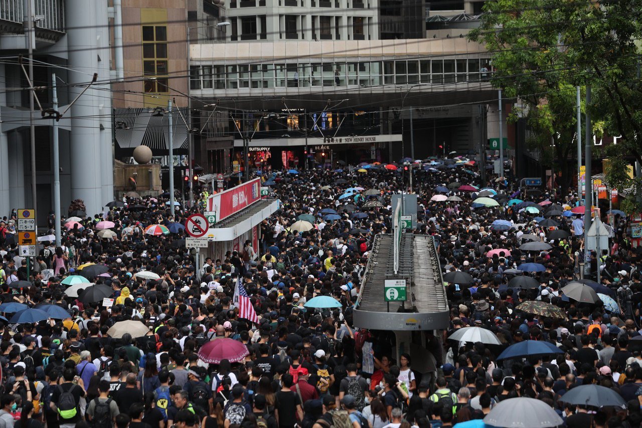 Hong Kong protesters ignore police warnings and take over roads