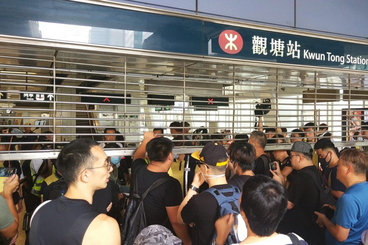 Hongkongers confront MTR staff over closure of train services before protest