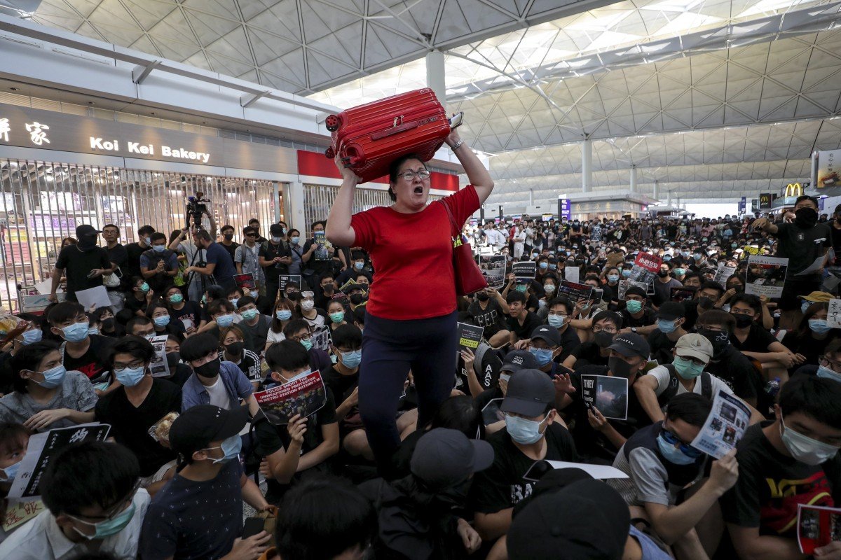 Check-ins suspended as protesters swarm Hong Kong airport for second day