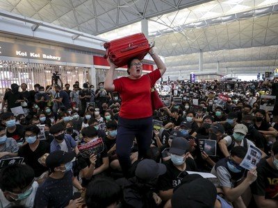 Check-ins suspended as protesters swarm Hong Kong airport for second day