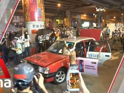 Hong Kong protesters smash taxi with sticks in Wan Chai