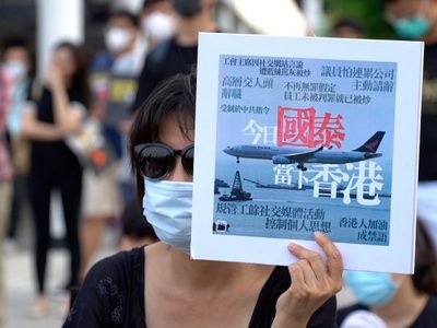 Protest-hit Cathay cuts flights, freezes hiring and spending