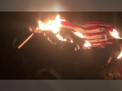 Protesters in Portland burn US flag and draped it around a George Washington Statue they later pulled down