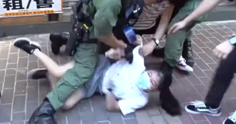 Hong Kong police violently arrest 12-year-old girl – video