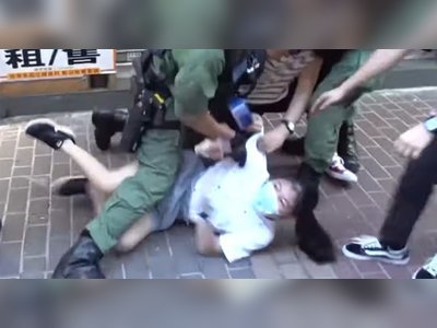 Hong Kong police violently arrest 12-year-old girl – video