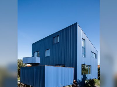 A Blue House Clad With Corrugated Steel Blends Into the Scandinavian Sky