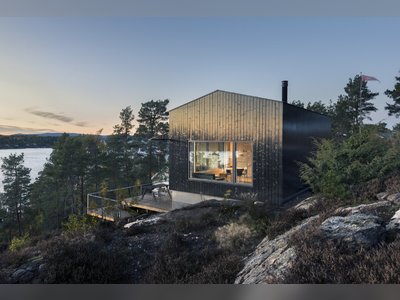 A Spruce-Clad Family Cabin in Norway Hugs Its Cinematic Landscape