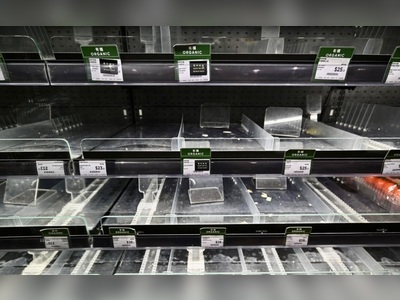 Emptied supermarket shelves await severe tropical storm Kompasu
