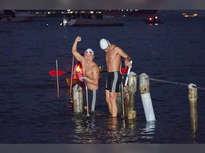 Alex Fong flexes muscles as he leads charity swim around HK Island