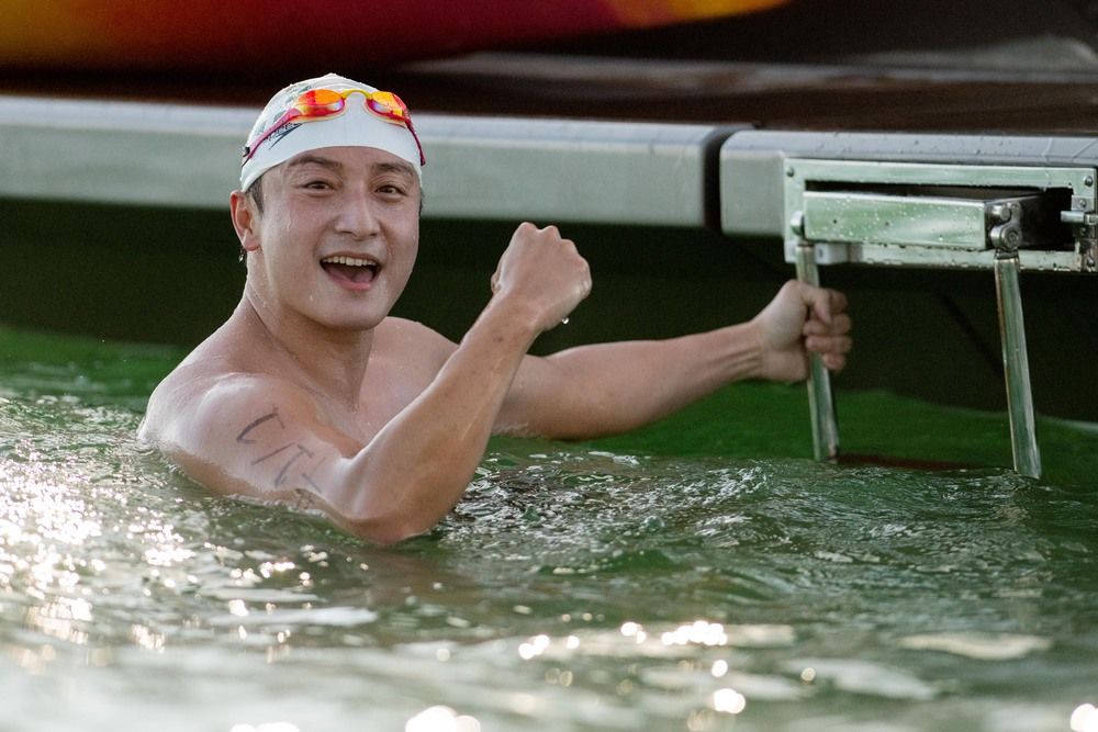Alex Fong flexes muscles as he leads charity swim around HK Island