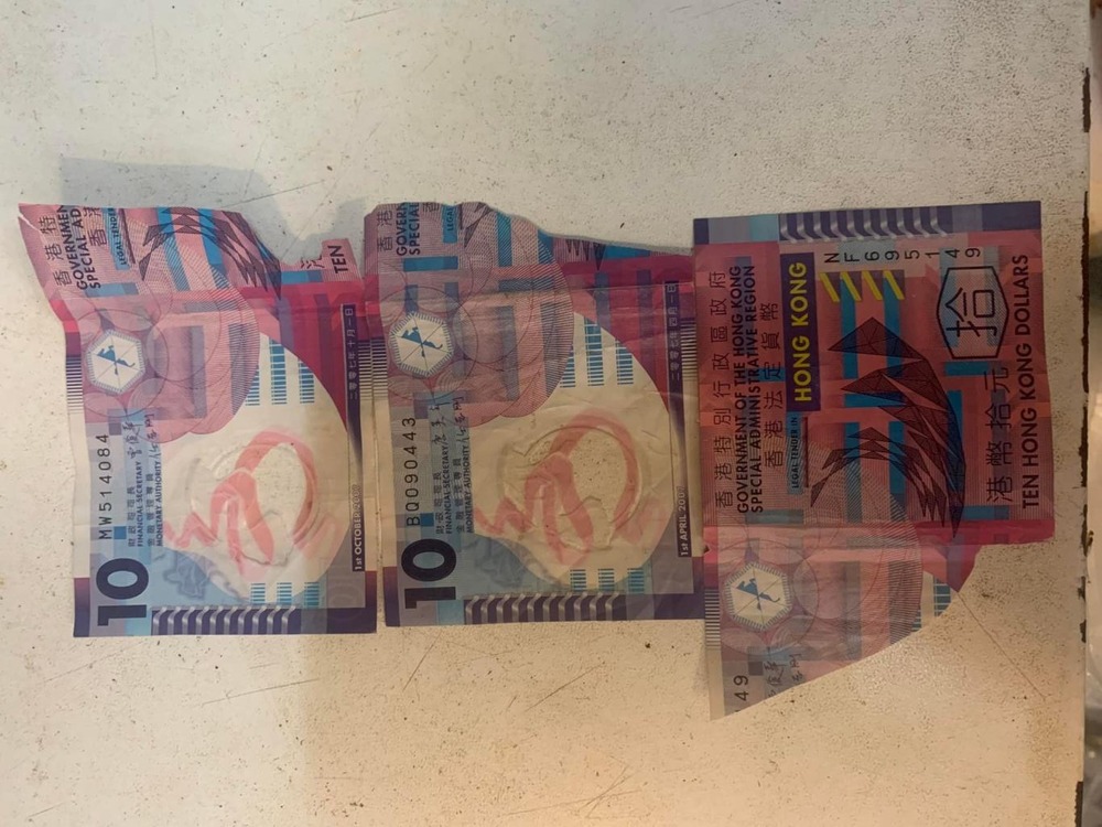 Man cuts HK$10 bills in half to cheat market vendors