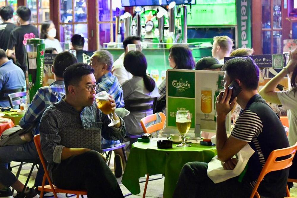 Citizens flock to bars and karaoke lounges on the first day of reopening