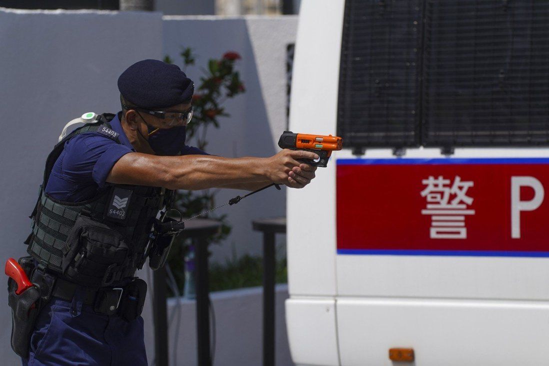 Hong Kong police say officer pointed pepper solution launcher, not gun, at suspect