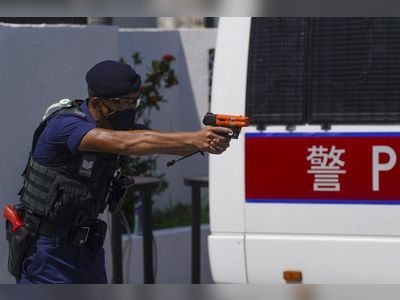 Hong Kong police say officer pointed pepper solution launcher, not gun, at suspect