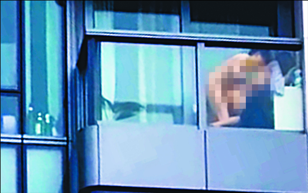 Woman arrested amid hunt for her balcony-sex partner