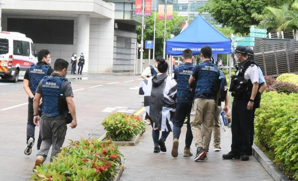 Reporters at West Kowloon station must use designated blue umbrellas