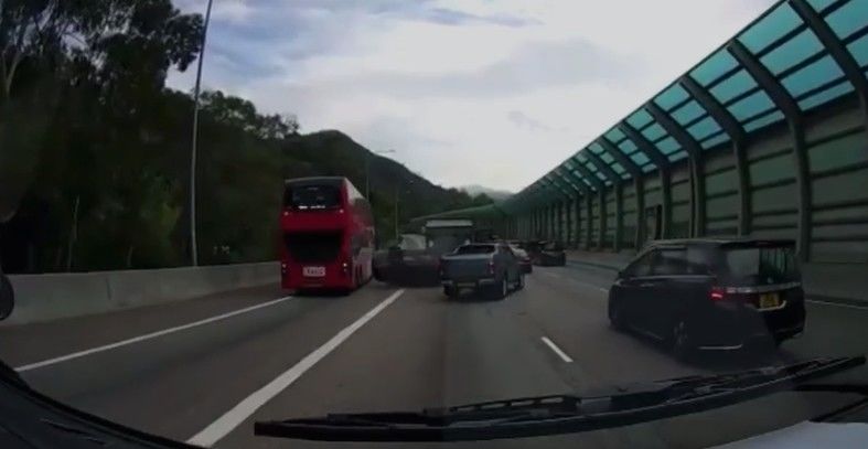 Private car collided as entering bus lane, driver trapped