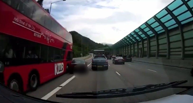 Private car collided as entering bus lane, driver trapped