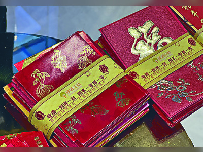 Green group hands out nearly 2 million recycled red packets