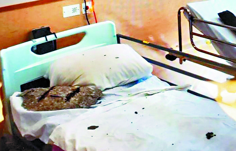 Chunk of concrete falls next to ward-bed pillow