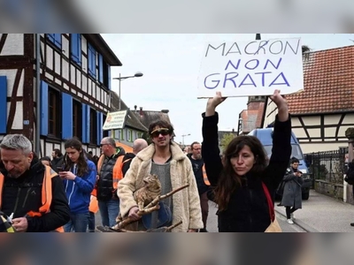 Macron tries to escape French pension row with street song