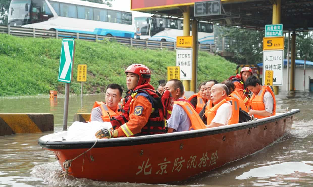People evacuated by rescue boat in the Fangshan district of Beijing