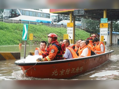 People evacuated by rescue boat in the Fangshan district of Beijing